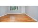 Bright living room featuring hardwood floors, natural light, and neutral wall color at 2218 W Fifth Ave, Gastonia, NC 28052