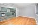 Living room highlighting hardwood floors and adjacent kitchen area at 2218 W Fifth Ave, Gastonia, NC 28052