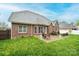 Brick home showcasing a spacious backyard with a patio and lush green lawn at 236 Riley Dr, Taylorsville, NC 28681