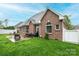 Beautiful brick home with a patio, lush green lawn, and well-manicured landscaping at 236 Riley Dr, Taylorsville, NC 28681