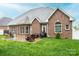 Brick home featuring a patio area, well-maintained lawn, and outdoor seating, perfect for entertaining at 236 Riley Dr, Taylorsville, NC 28681