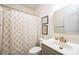 Bathroom featuring a shower with patterned curtain, grey vanity with brass fixtures at 236 Riley Dr, Taylorsville, NC 28681