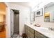 Bathroom with a double sink vanity and an open door to the shower at 236 Riley Dr, Taylorsville, NC 28681