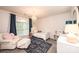 Bright bedroom with a large window, chandelier, and cozy seating area at 236 Riley Dr, Taylorsville, NC 28681