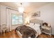 Cozy bedroom with a large window, soft lighting, and hardwood floors at 236 Riley Dr, Taylorsville, NC 28681