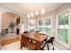 Charming dining area with ample natural light, a wooden table with seating, and adjacent living space at 236 Riley Dr, Taylorsville, NC 28681