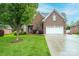 Beautiful brick home with a two-car garage, well-manicured lawn, and mature trees at 236 Riley Dr, Taylorsville, NC 28681