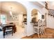 Bright open kitchen with stainless steel appliances, arched doorways, tile flooring, and bar seating at 236 Riley Dr, Taylorsville, NC 28681