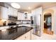 Bright kitchen with stainless appliances, white cabinets, and an island with a dark countertop at 236 Riley Dr, Taylorsville, NC 28681