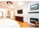 Another angle of the main bedroom featuring a fireplace, hardwood floors, bay windows, and a seating area at 236 Riley Dr, Taylorsville, NC 28681