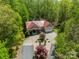 Stunning aerial view of home with a red metal roof and mature landscaping at 2599 Highway 557 None, Clover, SC 29710