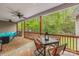 Covered back deck with ceiling fans, outdoor dining set, and comfortable seating offers a relaxing space with scenic views at 2599 Highway 557 None, Clover, SC 29710