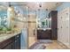 Bright bathroom featuring dual granite vanities, a glass-enclosed shower, decorative lighting and pale-blue walls at 2599 Highway 557 None, Clover, SC 29710