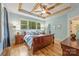 Charming bedroom with natural light and tray ceilings features a wooden sleigh bed, side tables, and light-blue colored walls at 2599 Highway 557 None, Clover, SC 29710