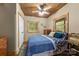 Comfortable bedroom with blue bedding, wood ceiling, and bright natural light from two windows at 2599 Highway 557 None, Clover, SC 29710