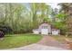 Detached garage with multiple bays, white doors, and an extra-wide driveway at 2599 Highway 557 None, Clover, SC 29710