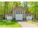 Spacious three car garage with white doors and a red roof, surrounded by trees at 2599 Highway 557 None, Clover, SC 29710