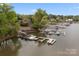 Stunning aerial view of a waterfront home with a private dock and boat slips at 263 Fernbrook Dr, Mooresville, NC 28117