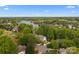 Scenic aerial view of a residential area with lush trees and a lake at 263 Fernbrook Dr, Mooresville, NC 28117