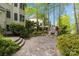 Stone patio with outdoor fireplace surrounded by lush greenery creates a cozy and inviting entertainment space at 263 Fernbrook Dr, Mooresville, NC 28117