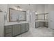Bright bathroom with double sinks, large mirrors, and elegant marble flooring at 263 Fernbrook Dr, Mooresville, NC 28117