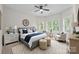 A relaxing bedroom with a plush rug, a decorative clock, and large windows with white shutters for plenty of light at 263 Fernbrook Dr, Mooresville, NC 28117