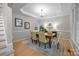 Elegant dining room with tray ceiling, chandelier, and hardwood floors at 263 Fernbrook Dr, Mooresville, NC 28117