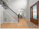Bright foyer featuring staircase with iron spindles and entry to the dining room at 263 Fernbrook Dr, Mooresville, NC 28117