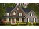 Charming two-story house featuring stone accents, a front porch, and manicured landscaping at 263 Fernbrook Dr, Mooresville, NC 28117