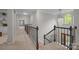 Bright hallway with staircase featuring elegant chandelier and dark wooden banister at 263 Fernbrook Dr, Mooresville, NC 28117