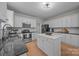 Well-lit kitchen with sleek stainless steel appliances, granite countertops, and white cabinets, providing ample cooking space at 263 Fernbrook Dr, Mooresville, NC 28117