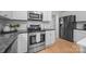 Modern kitchen with stainless appliances, granite countertops, and white cabinets, offering a stylish cooking experience at 263 Fernbrook Dr, Mooresville, NC 28117