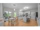 Eat-in kitchen features white cabinets, stainless appliances, island, and light wood floors at 263 Fernbrook Dr, Mooresville, NC 28117