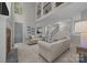 Open-concept living room featuring soaring ceilings and elegant design with cozy couches and a stone fireplace at 263 Fernbrook Dr, Mooresville, NC 28117