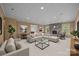 Spacious living room with stone fireplace, adjacent dining area, and a large sectional sofa for comfortable living at 263 Fernbrook Dr, Mooresville, NC 28117