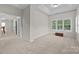 Bright main bedroom with tray ceiling, large windows with views, and neutral walls at 263 Fernbrook Dr, Mooresville, NC 28117