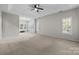 Spacious main bedroom featuring tray ceiling, large windows, and neutral carpeting at 263 Fernbrook Dr, Mooresville, NC 28117