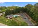 An aerial view of the pool and parking amenities at a community nestled in a lush landscape at 263 Fernbrook Dr, Mooresville, NC 28117