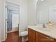 Bathroom with a vanity and sink, toilet, and shower with blue curtain at 2731 Meadow Knoll Dr, Charlotte, NC 28269