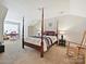 Spacious bedroom with a four poster bed, rocking chair, and an office area with desk and rolling chair at 2731 Meadow Knoll Dr, Charlotte, NC 28269