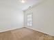 Bright bedroom with neutral carpet, window with blinds, and ample natural light at 2731 Meadow Knoll Dr, Charlotte, NC 28269