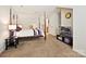 Bedroom features a four poster bed, a TV, and a side table with a lamp at 2731 Meadow Knoll Dr, Charlotte, NC 28269