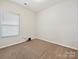 Bedroom featuring neutral carpet and window with blinds, ready for personalization at 2731 Meadow Knoll Dr, Charlotte, NC 28269