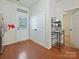 Hallway featuring hardwood floors, storage closet, and an exit door at 2731 Meadow Knoll Dr, Charlotte, NC 28269