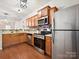 This kitchen features stainless steel appliances, wood cabinets, and neutral countertops at 2731 Meadow Knoll Dr, Charlotte, NC 28269