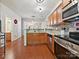 Kitchen view with wood-look flooring and stainless steel appliances and view to other rooms at 2731 Meadow Knoll Dr, Charlotte, NC 28269