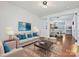 Bright living room featuring hardwood floors, neutral furniture, and an open floor plan at 2731 Meadow Knoll Dr, Charlotte, NC 28269
