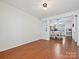 Empty living room featuring hardwood floors and open access to the adjacent dining area at 2731 Meadow Knoll Dr, Charlotte, NC 28269