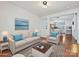 Cozy living room showcasing hardwood floors, natural light, and access to the dining area at 2731 Meadow Knoll Dr, Charlotte, NC 28269