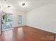 Open living room area with wood-look flooring and natural light from the front door at 2731 Meadow Knoll Dr, Charlotte, NC 28269